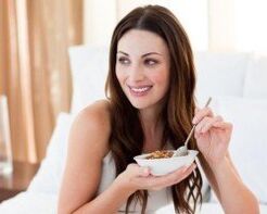 The girl eats Sarracene wheat porridge